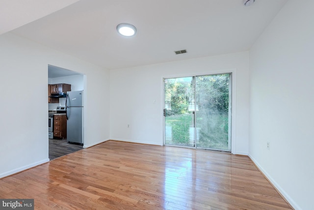 spare room with light wood-type flooring