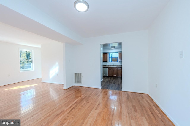 empty room with light hardwood / wood-style floors and sink