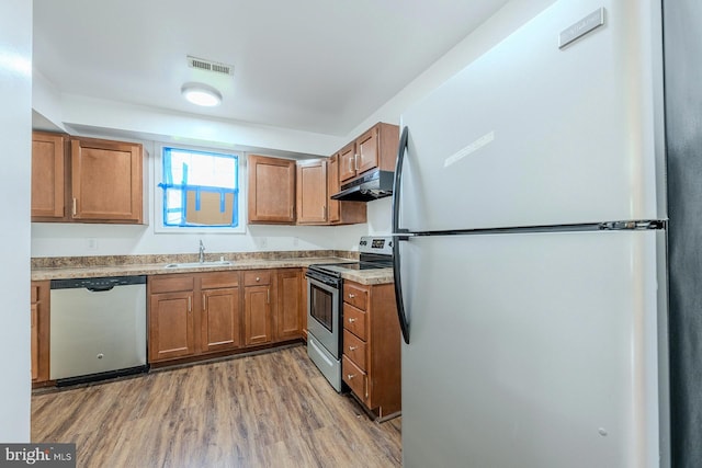 kitchen featuring sink, stainless steel appliances, and wood-type flooring