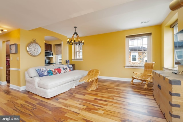 dining room with an inviting chandelier and light wood-type flooring