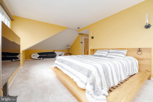 bedroom featuring carpet and vaulted ceiling