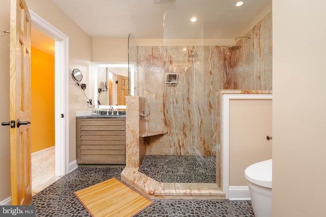 bathroom with a tile shower, tile patterned floors, and vanity