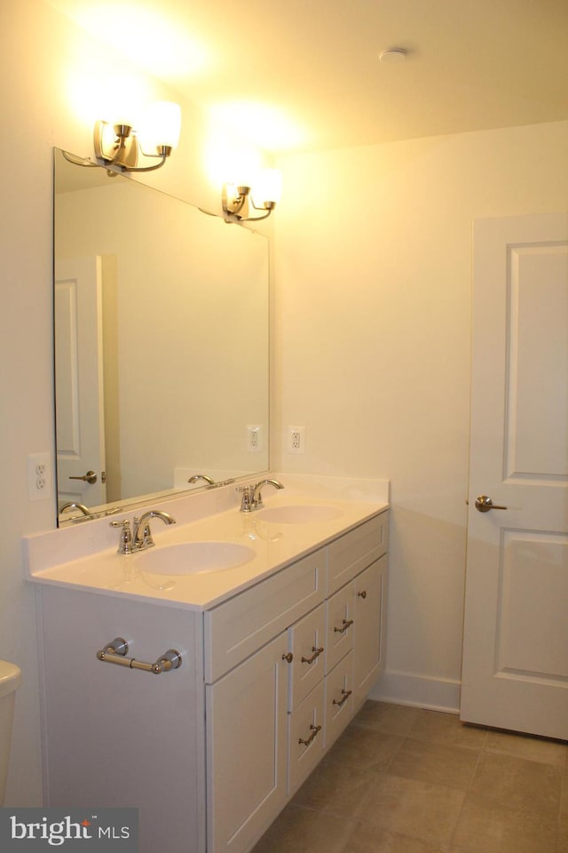 bathroom with vanity, toilet, and tile patterned floors