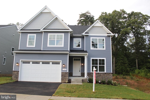 craftsman-style house featuring a garage and a front lawn