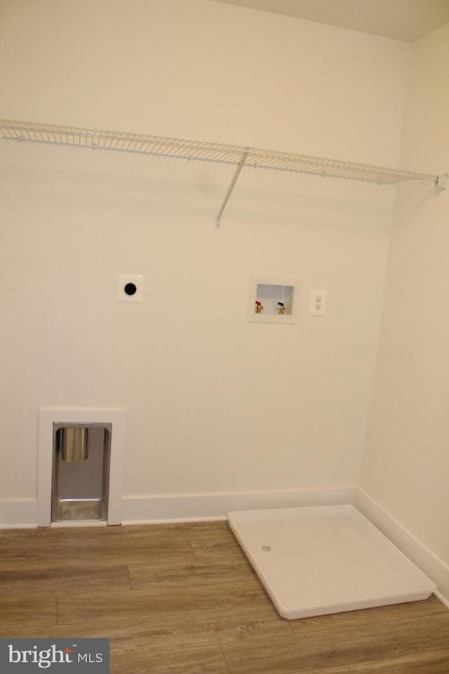 clothes washing area featuring washer hookup, hookup for an electric dryer, and hardwood / wood-style floors