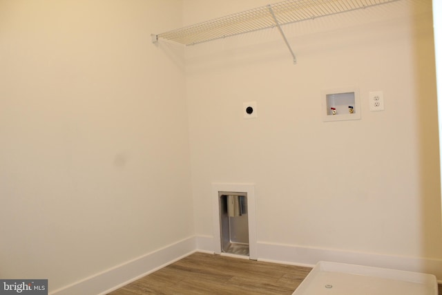 clothes washing area with hookup for a washing machine, wood-type flooring, and hookup for an electric dryer