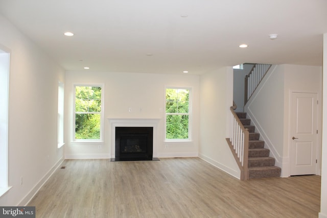 unfurnished living room with light wood-type flooring