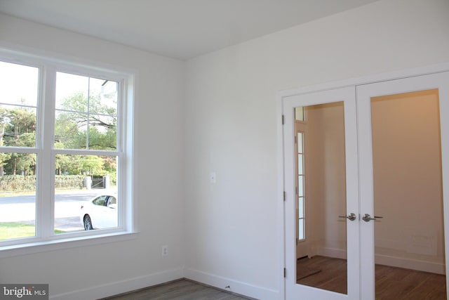 unfurnished room featuring dark hardwood / wood-style floors and french doors