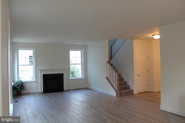 unfurnished living room with hardwood / wood-style floors