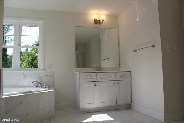 bathroom with vanity and tiled bath