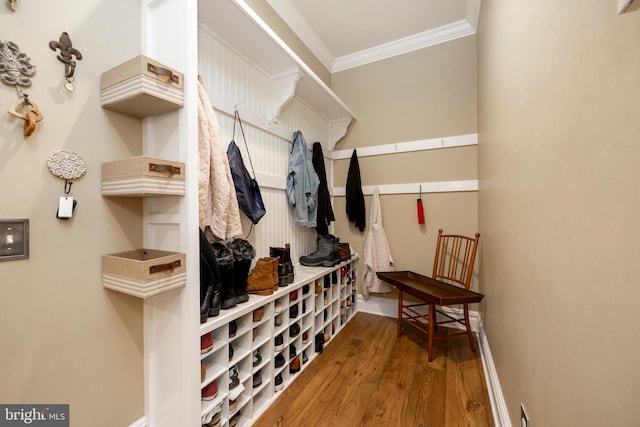 mudroom with ornamental molding and hardwood / wood-style floors