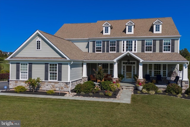 view of front facade featuring covered porch and a front yard