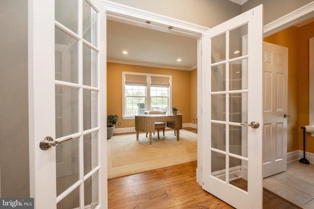 doorway to outside with french doors, light hardwood / wood-style flooring, and crown molding