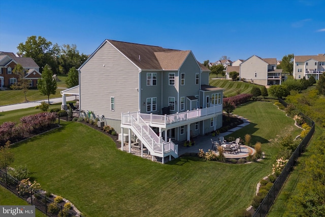 rear view of house with a patio, a yard, and a wooden deck