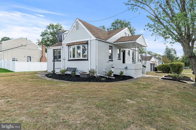 view of front of house featuring a front yard and central AC