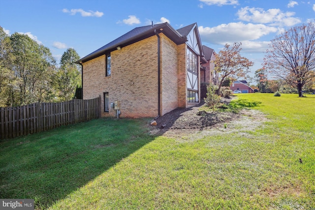 view of side of home featuring a lawn