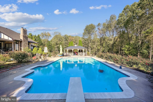 view of pool featuring a diving board, a patio, and a gazebo