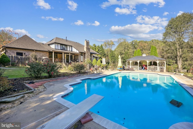 view of swimming pool with a diving board, a patio, and a gazebo