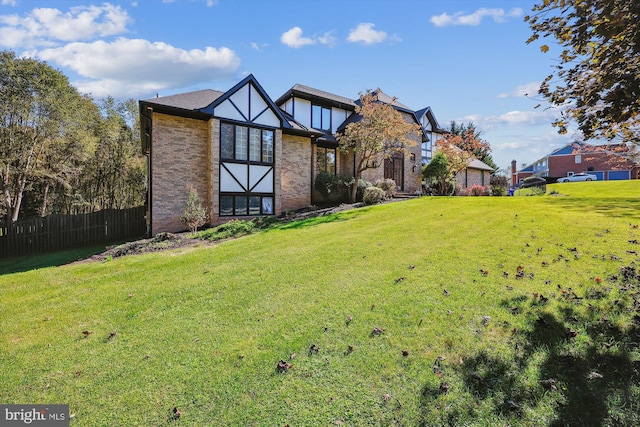 rear view of house featuring a lawn