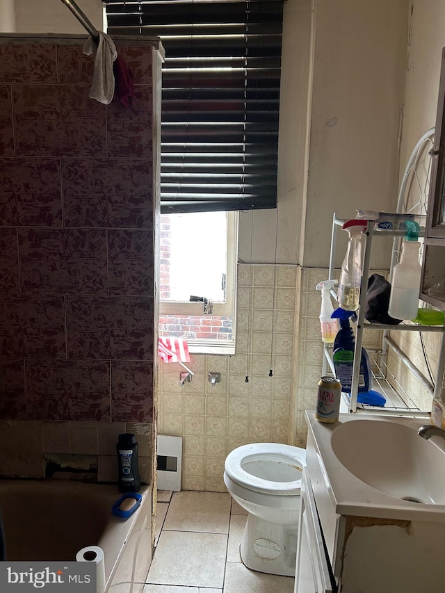 bathroom with vanity, tile walls, tile patterned flooring, and toilet