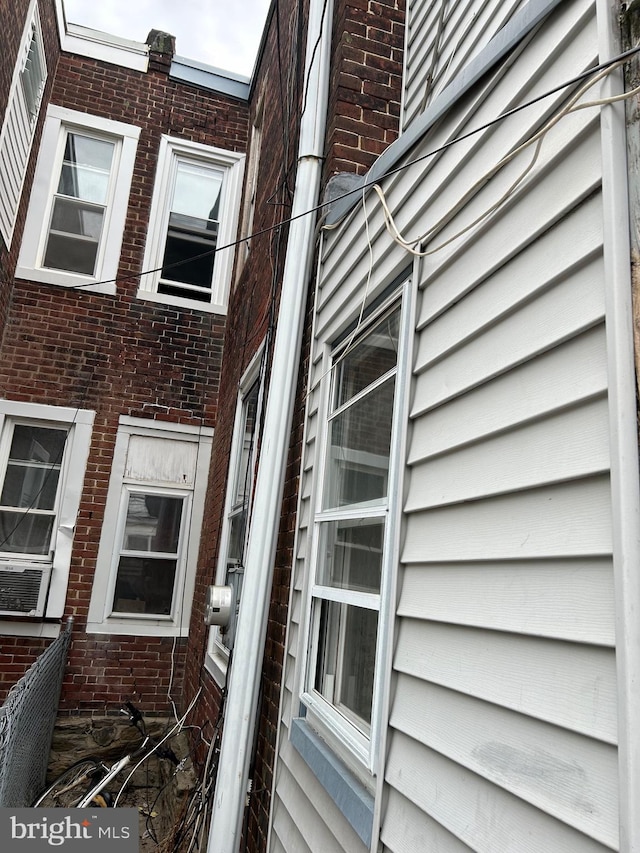 view of side of home featuring cooling unit