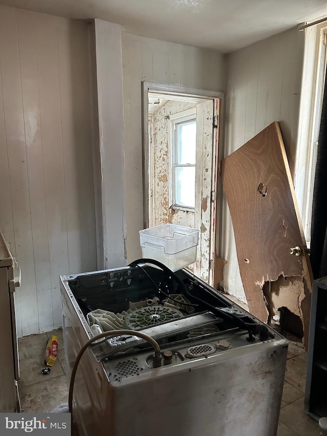 bathroom with wooden walls and tile patterned floors