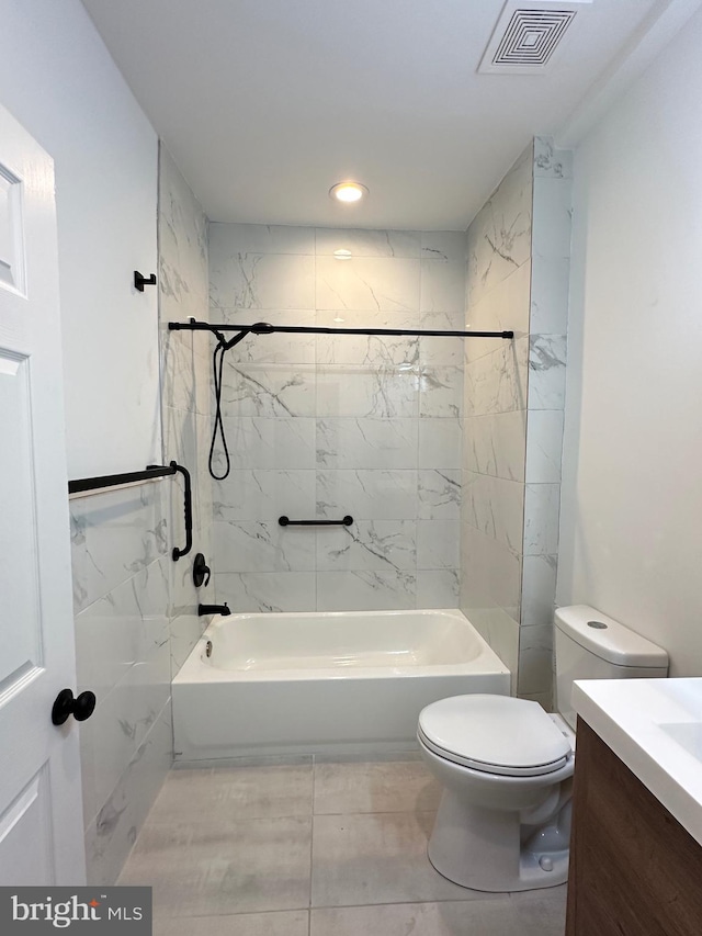 full bathroom with vanity, tiled shower / bath combo, and toilet