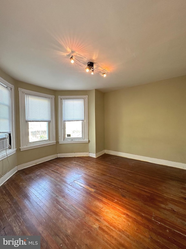 spare room with cooling unit and hardwood / wood-style flooring