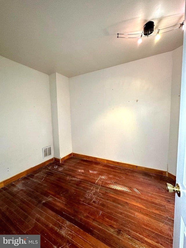 unfurnished room featuring dark hardwood / wood-style floors