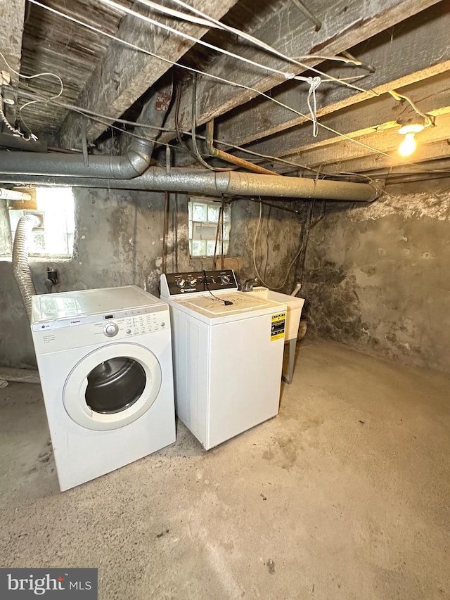 basement with a wealth of natural light, separate washer and dryer, and sink