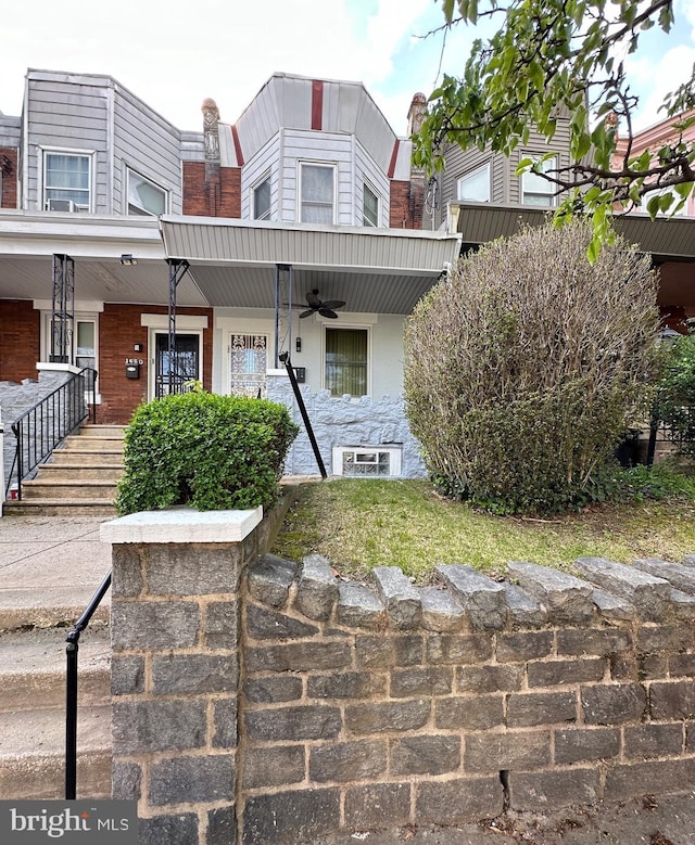 multi unit property featuring a porch and ceiling fan