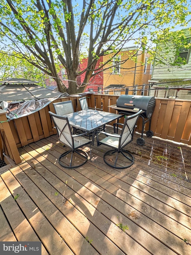 wooden deck featuring a grill