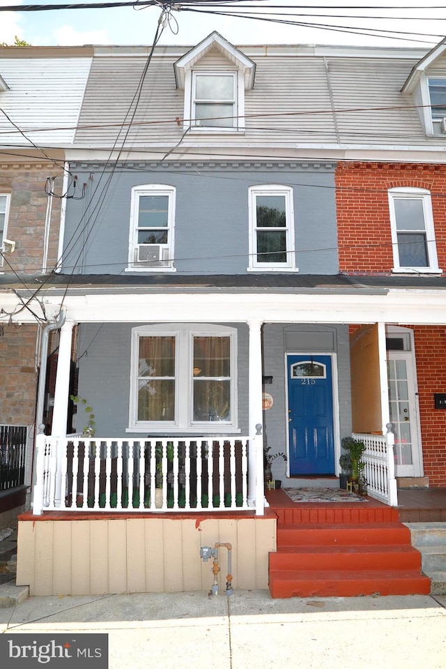 townhome / multi-family property featuring a porch