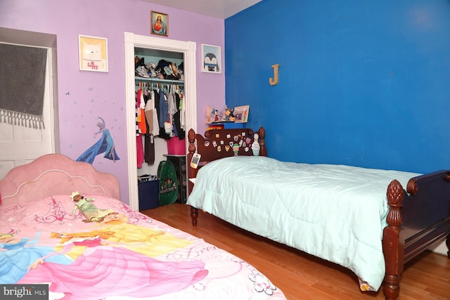 bedroom with wood-type flooring and a closet