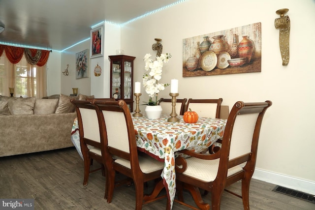 dining area featuring dark hardwood / wood-style flooring