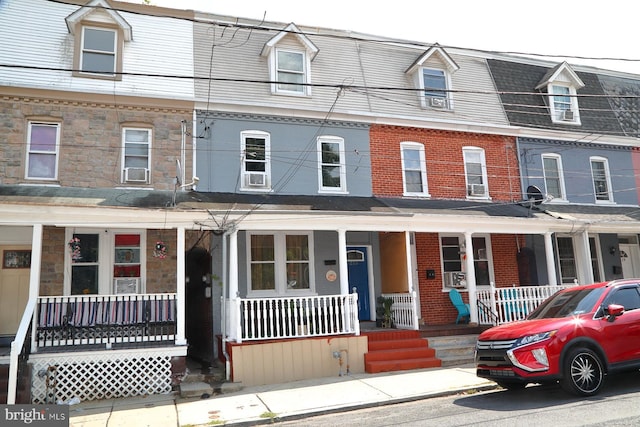 townhome / multi-family property featuring a porch