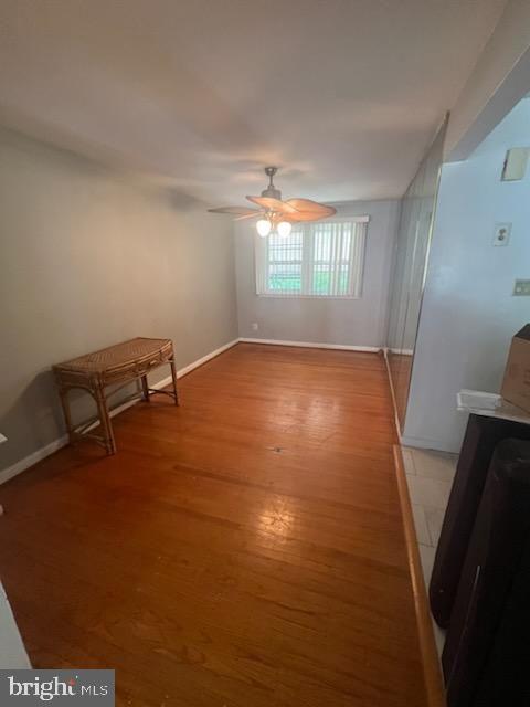 unfurnished room with ceiling fan and light hardwood / wood-style floors