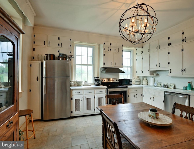 kitchen featuring hanging light fixtures, white cabinetry, an inviting chandelier, and stainless steel appliances