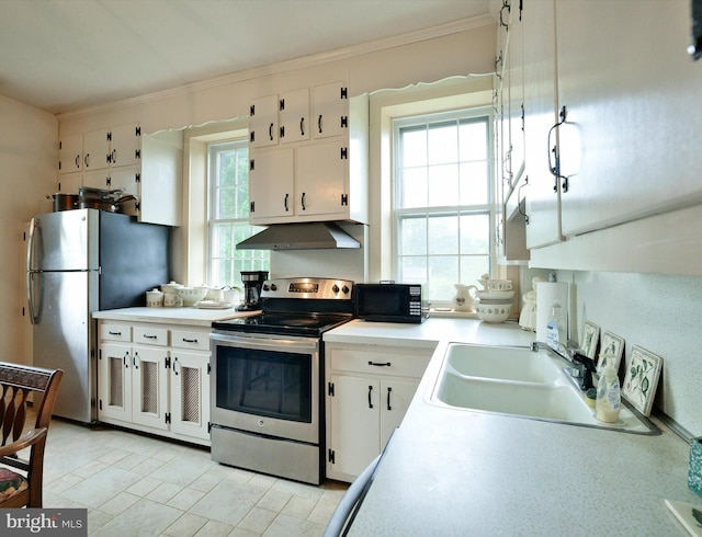 kitchen featuring appliances with stainless steel finishes, crown molding, sink, and white cabinetry