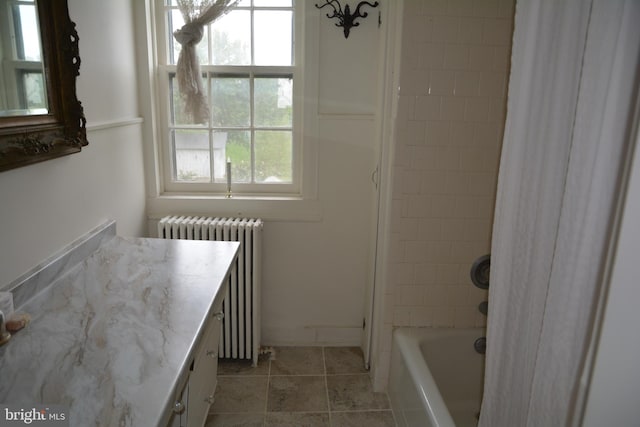 bathroom featuring shower / bathtub combination with curtain, radiator, tile patterned flooring, and vanity