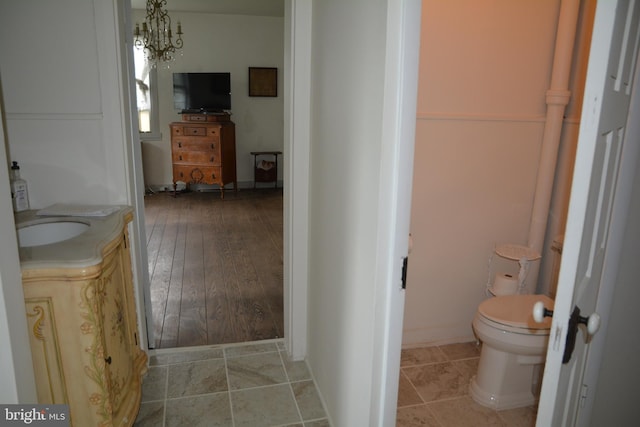 bathroom featuring hardwood / wood-style flooring, vanity, and toilet