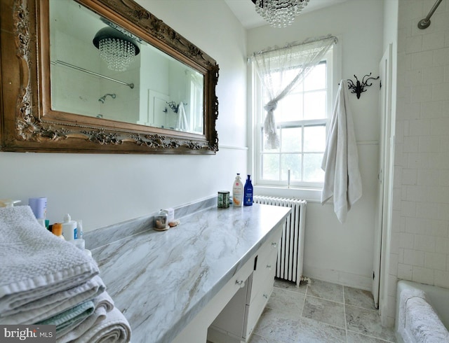 bathroom featuring radiator heating unit and vanity