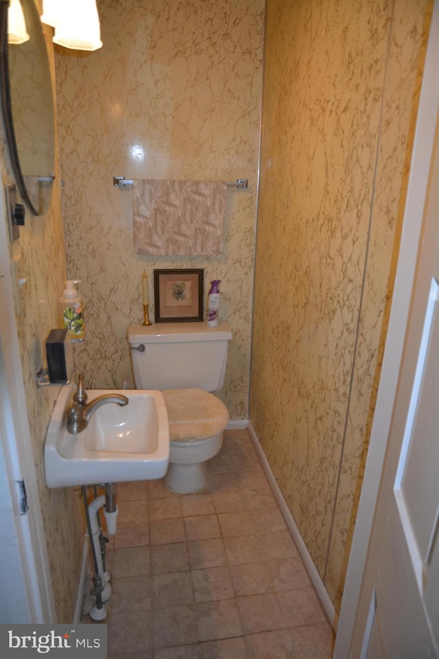 bathroom featuring sink, tile patterned flooring, and toilet