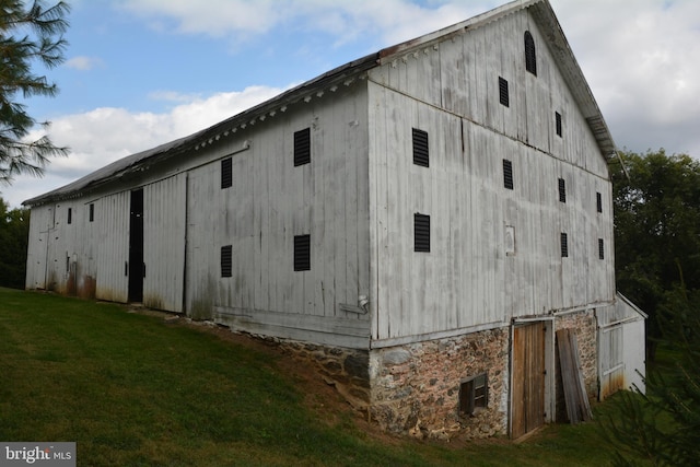 view of property exterior with a yard