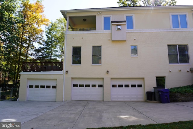 exterior space featuring a balcony and a garage