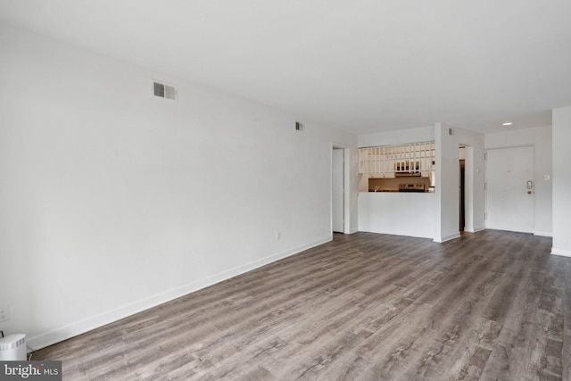 unfurnished living room with hardwood / wood-style flooring