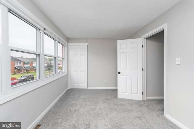 1704 Melbourne Rd, Dundalk, MD 21222 - unfurnished bedroom featuring baseboards, a closet, and carpet flooring