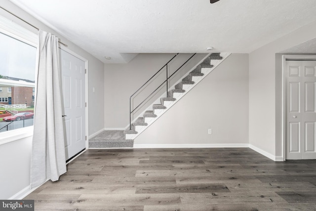 entryway featuring a textured ceiling and hardwood / wood-style floors