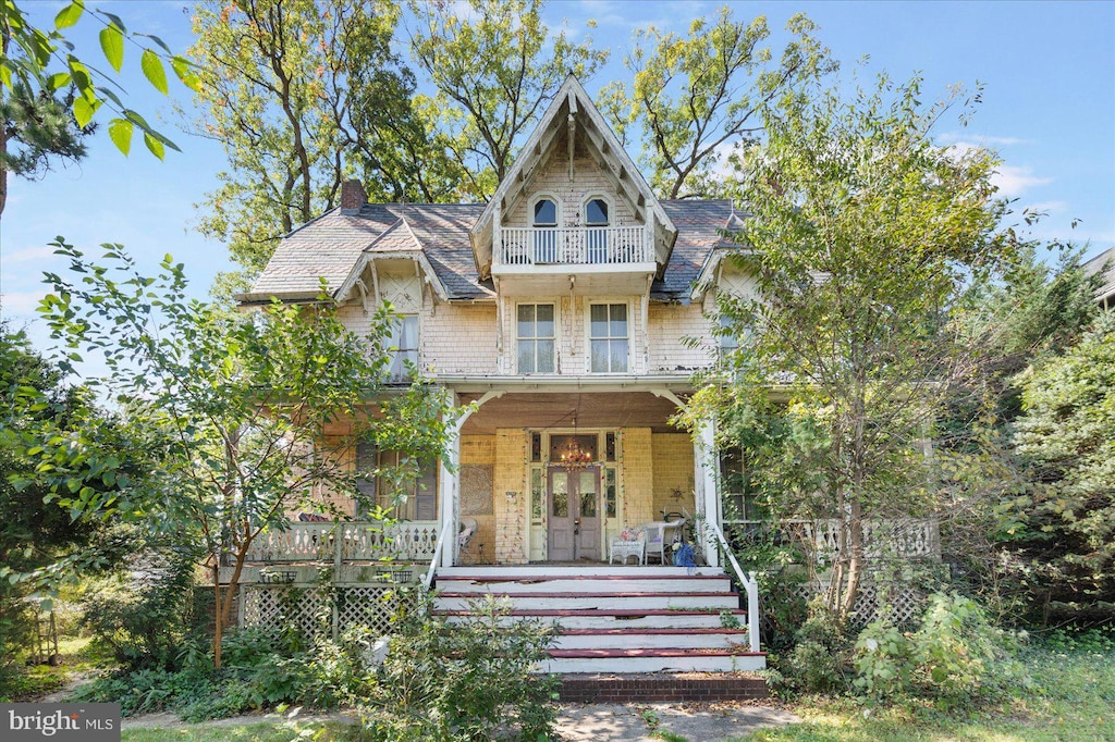 victorian home with a porch and a balcony