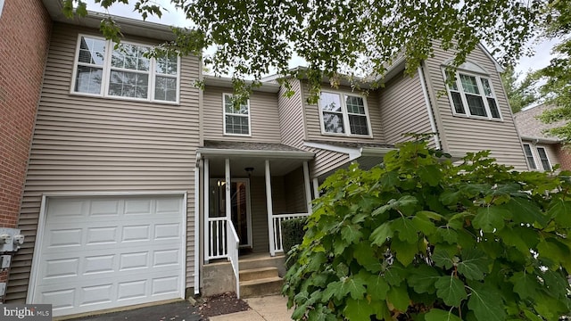 view of front of property featuring a garage and a porch